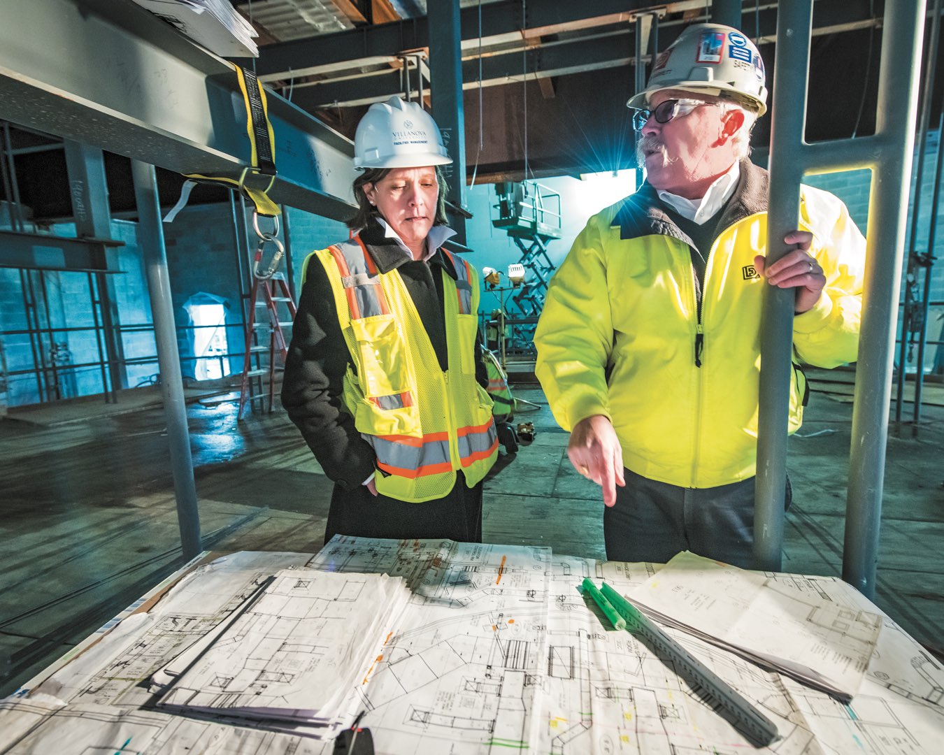 Marilou Smith reviews architectural plans on site for Villanova Performing Arts Center with LF Driscoll site superintendent 