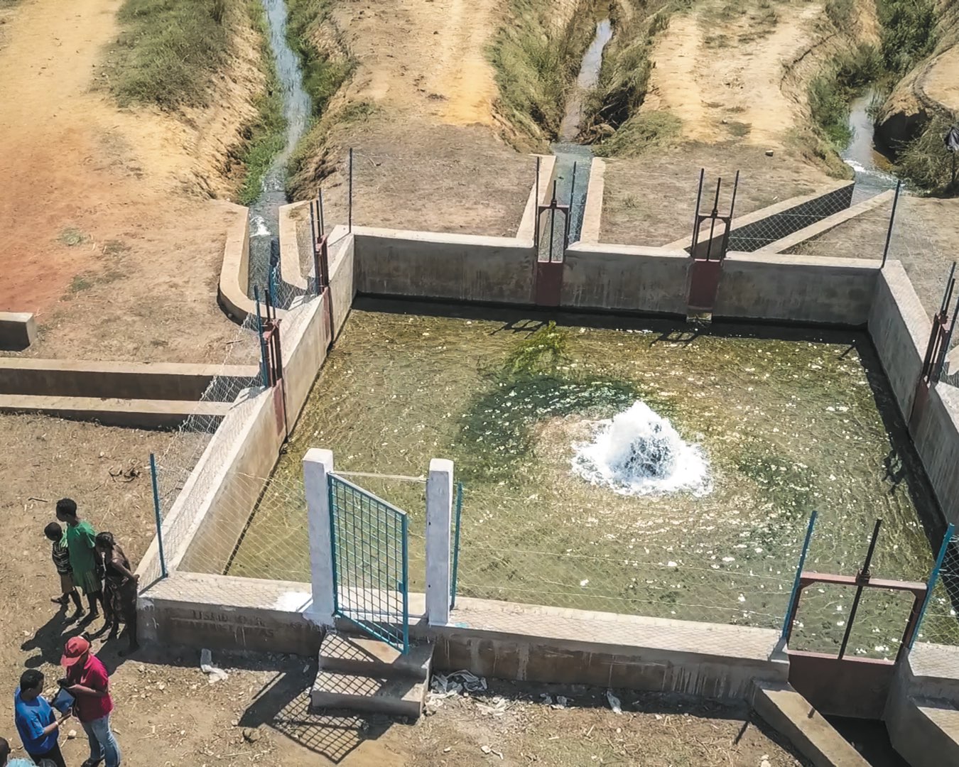 An aerial shot of a concrete pool of water that delivers water for crop irrigation and livestock