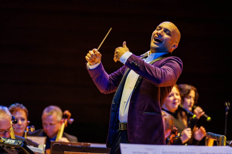 Christopher Dragon of the Philly Pops conducting on stage