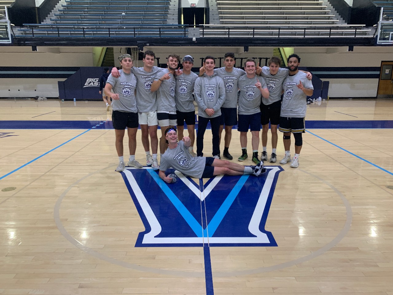 Male students posing for basketball champion photo