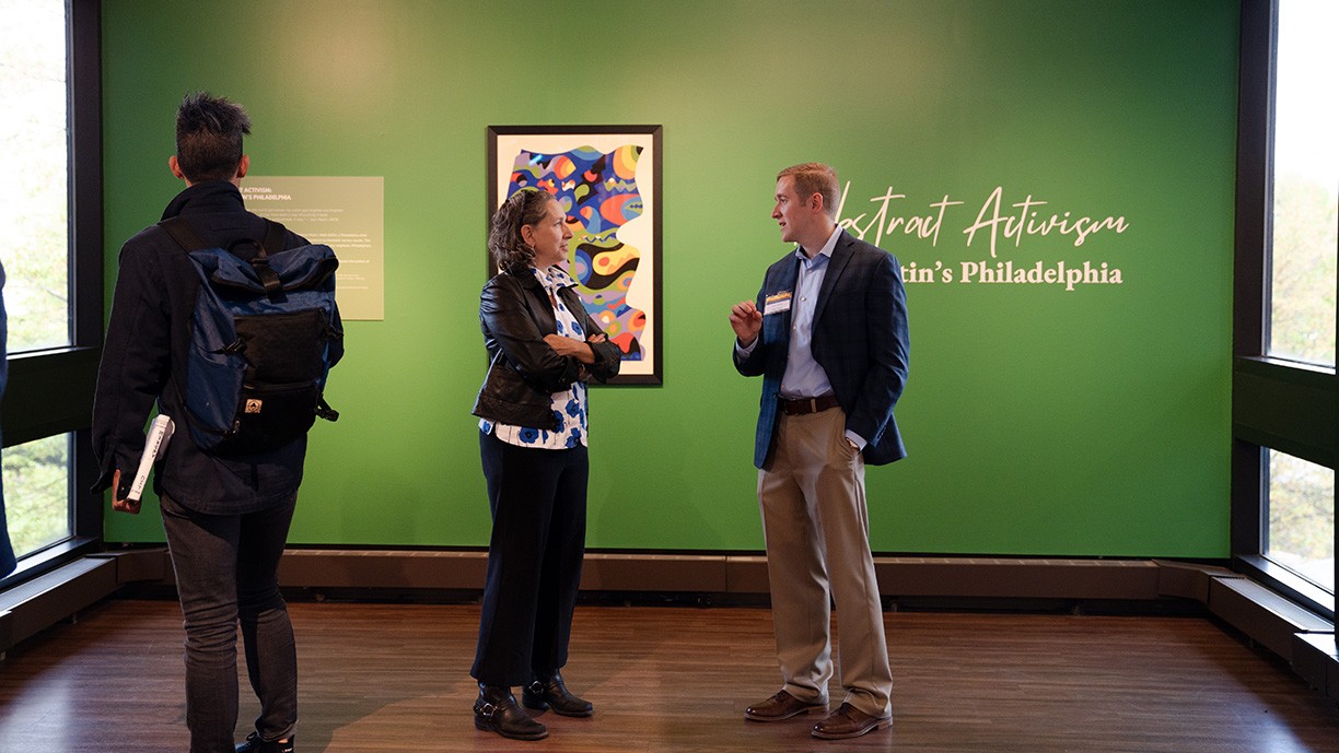 Patrons look at Sam Maitin art exhibit. Patrons look at Sam Maitin art exhibit.