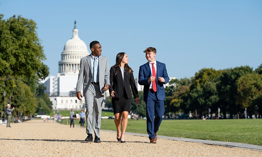 Three students walk in Washington, D.C., during an immersion trip. Three students walk in Washington, D.C., during an immersion trip.