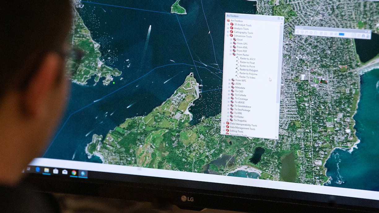 Department of Geography and the Environment. A student looks at a mapping program in class.