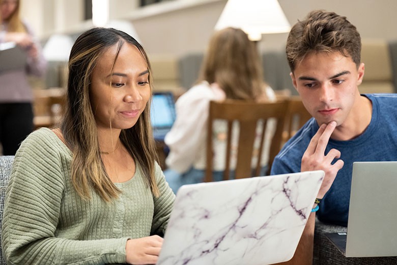 male-female-student-laptop Male and female student viewing laptop
