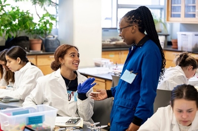 graduate student mentoring undergrauate students in a lab