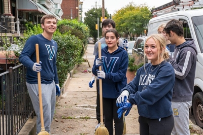 students participating in a neighborhood clean-up service activity