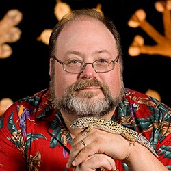 Aaron Bauer holds a lizard. Aaron Bauer holds a lizard.