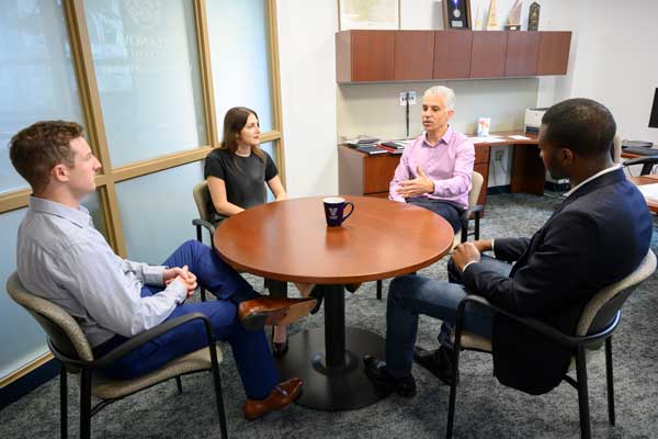 Students and faculty sitting around a table
