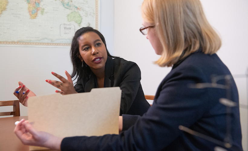 A clinic student speaks with her faculty adviser.