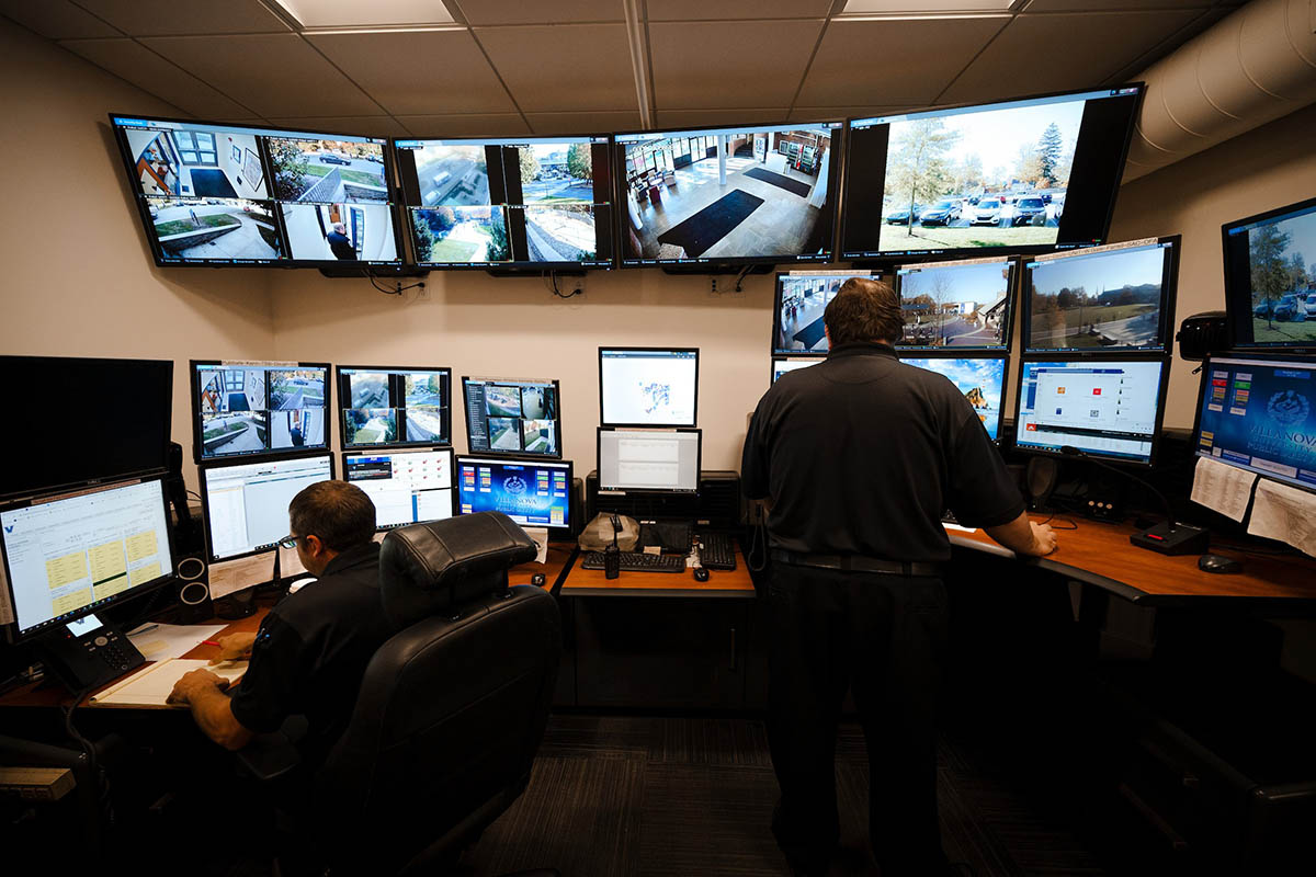 Public safety officers at a desk with computer monitors