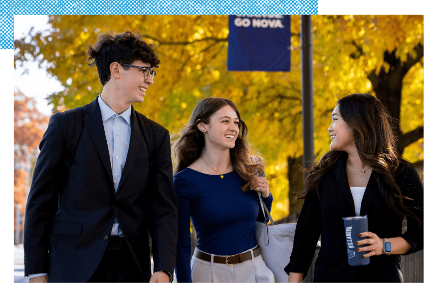 Students walking on campus in professional attire.
