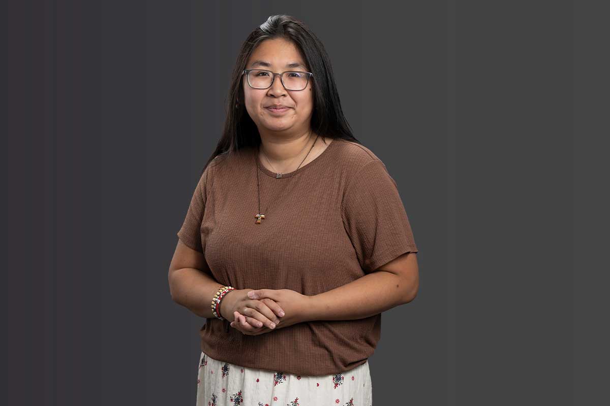 Sister Brigid Mary Meeks, RSM, in a standing pose with her hands clasped wearing her habit